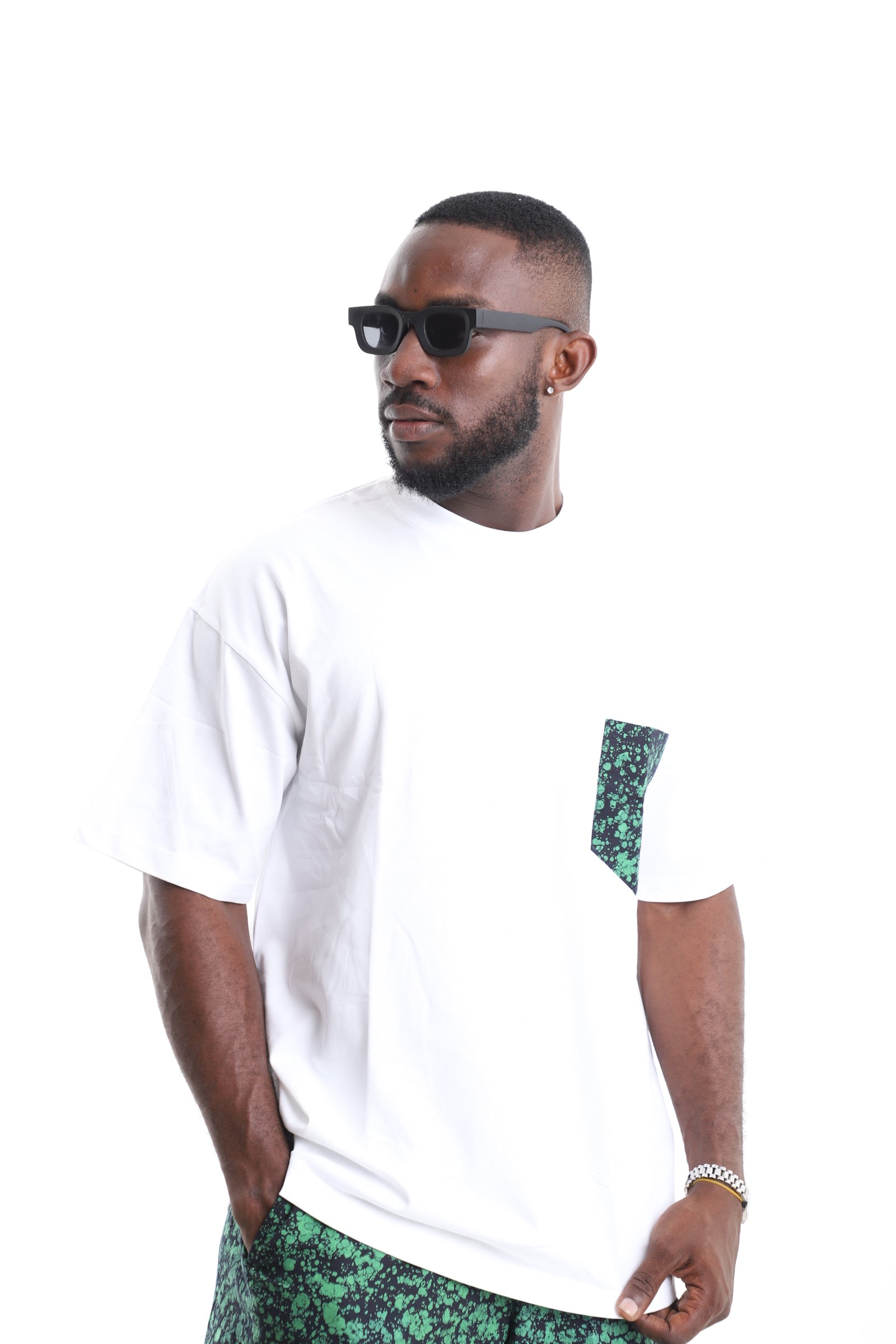 King Kaftan Cotton Oversized White T-Shirt with Emerald Splatter Adire Pocket Accent – Side View – African men's fashion Nigeria