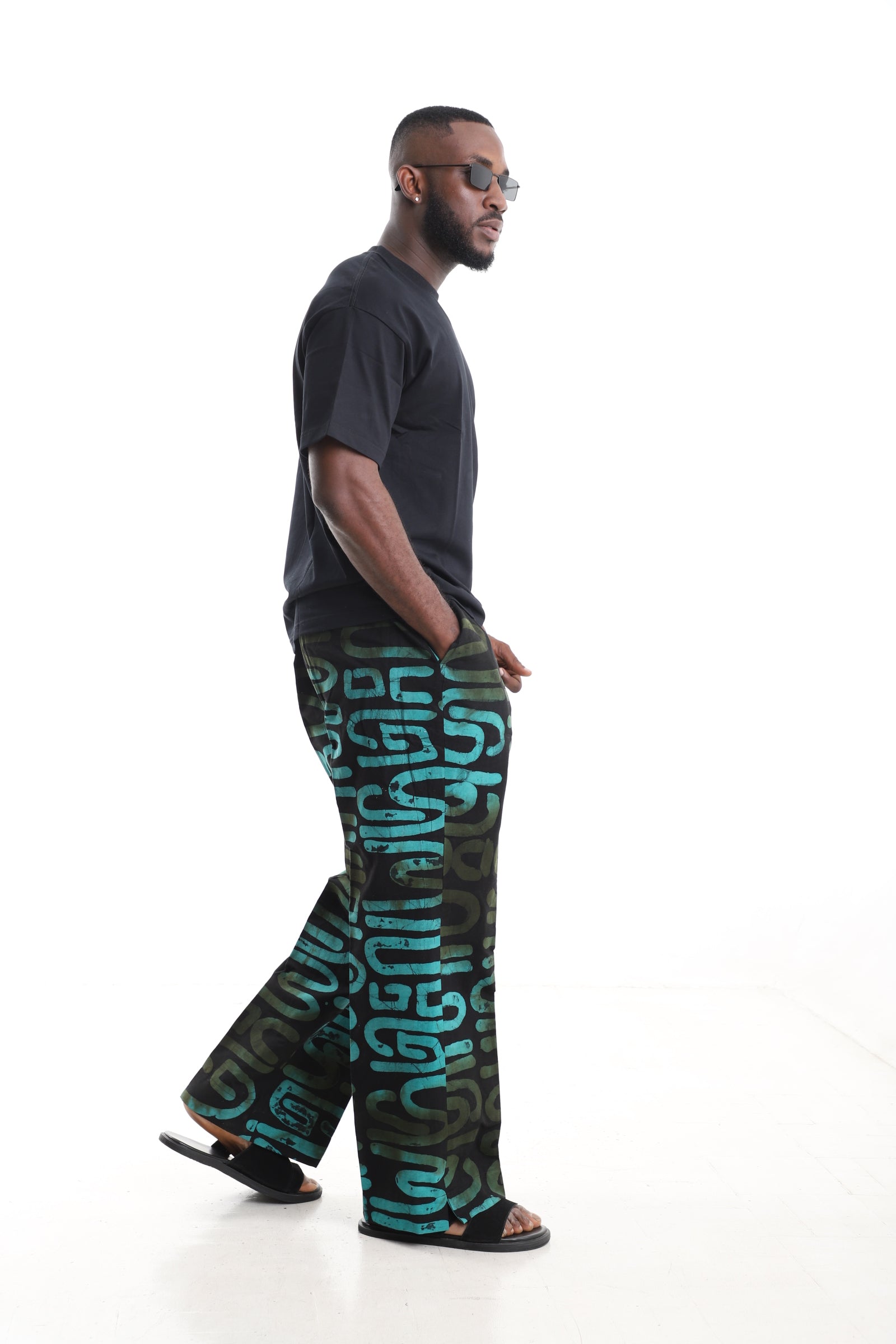 King Kaftan Black and Turquoise Calligraphy Adire Cargo Pants Set with Oversized Black T-Shirt – Side View – African men's fashion Nigeria