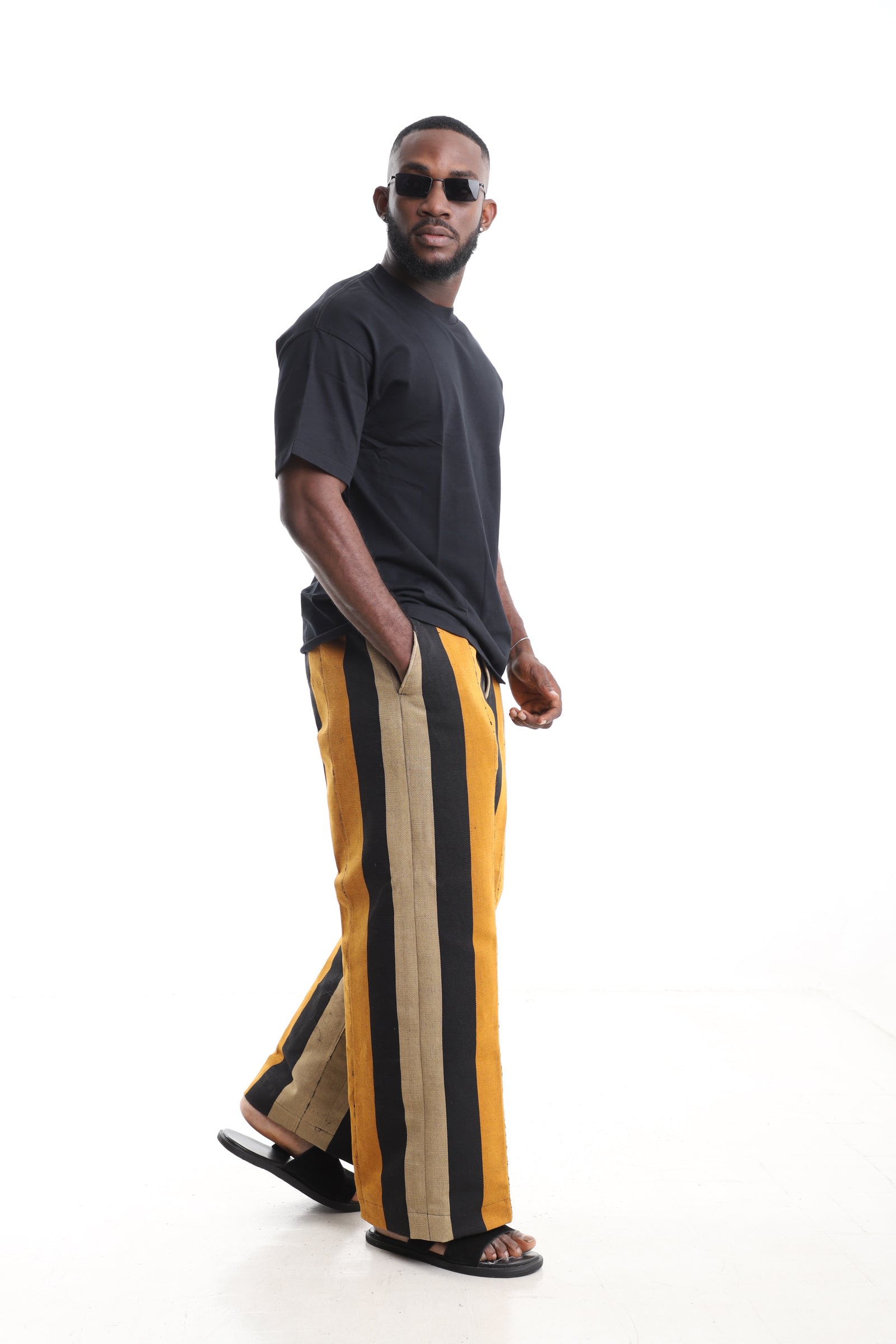 King Kaftan Handwoven Striped Cotton Aso-Oke Pants Set with Oversized Black T-Shirt – Side View – African men's fashion Nigeria